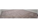 Full view of light beige carpet with white baseboard in room at 16195 Point Rock Dr, Winter Garden, FL 34787