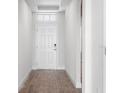 Inviting home entryway with wood-look tile flooring and natural light at 16195 Point Rock Dr, Winter Garden, FL 34787