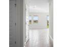 Bright hallway with wood-look tile, leading to a living space with a lake view at 16195 Point Rock Dr, Winter Garden, FL 34787