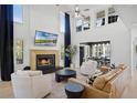 Soaring ceilings, fireplace, and modern finishes highlight this luxurious living space at 16692 Lake Pickett Rd, Orlando, FL 32820