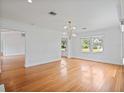 Bright living room with gleaming hardwood floors, white walls, and large windows offering ample natural light at 1702 N Westmoreland Dr, Orlando, FL 32804