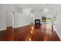 Open concept living room with hardwood floors, fireplace, high ceilings, and access to the pool at 1851 Sweetwater West Cir, Apopka, FL 32712