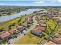 An aerial view shows the beautiful community, waterfront view, and location of this home at 1945 Via Lago Dr, Lakeland, FL 33810