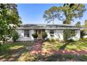 Inviting home exterior with a decorative front door and manicured landscaping at 228 Deleon Rd, Debary, FL 32713