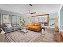 Open living room with modern decor, a ceiling fan, and an area to store cat supplies at 228 Deleon Rd, Debary, FL 32713