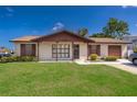 Charming single-story home with brick accents, shutters, and a well-maintained lawn at 2411 Trafalgar Dr, Orlando, FL 32837