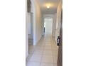 View of the home's bright entryway with tile flooring and arched doorways at 271 Tanglewood Dr, Davenport, FL 33896