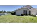 Back of the house shows a scenic lakeside view with a fountain at 271 Tanglewood Dr, Davenport, FL 33896