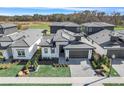 Stylish home boasts a two-car garage, stone accents, a well-kept lawn, and modern architectural details at 3024 Kensington Ave, Davenport, FL 33837