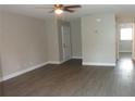Bright living room with wood-look floors, neutral paint, ceiling fan, and welcoming atmosphere at 3060 George Mason Ave # 10C, Winter Park, FL 32792