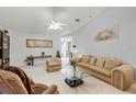 Bright living room featuring comfortable seating, neutral decor, and a welcoming atmosphere at 32537 Oak Park Dr, Leesburg, FL 34748