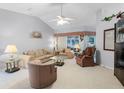 Spacious living room with high ceilings, plush furnishings, and ample natural light at 32537 Oak Park Dr, Leesburg, FL 34748