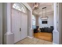 Stately foyer showcasing double doors, ceramic tile flooring, and a view of the office with light wood floors at 3436 Herringridge Dr, Orlando, FL 32812