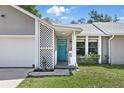 Close up of the home's entrance, featuring a blue door and lattice details at 5163 Lighthouse Rd, Orlando, FL 32808