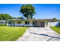 Well-maintained home with an expansive driveway and lush green lawn, perfect for outdoor enjoyment at 605 Oranole Rd, Maitland, FL 32751