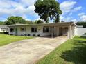 Single story home with a covered carport and well maintained lawn at 605 Oranole Rd, Maitland, FL 32751