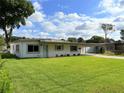 Landscaped front yard with a well maintained lawn, carport and mature trees at 605 Oranole Rd, Maitland, FL 32751