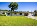 Inviting home with a well-maintained lawn and convenient carport offering protection from the elements at 605 Oranole Rd, Maitland, FL 32751