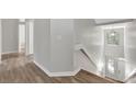 Neutral hallway leading to the staircase with a decorative window feature at 7021 Della Dr # 52, Orlando, FL 32819