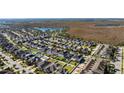 Scenic aerial view of a neighborhood with a beautiful pond and lush greenery in the distance at 8565 Tallfield Ave # 1, Orlando, FL 32832