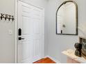 Entryway features modern black hardware on a white door, decorative hooks and mirror at 860 N Orange Ave # 226, Orlando, FL 32801