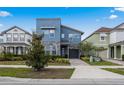 Beautiful two-story home with stone accents, complementing landscaping, and a gray-tone color scheme at 8953 Amelia Downs Trl, Kissimmee, FL 34747