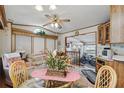 Cozy dining area with ceiling fan, wood trim, and open view to living area at 9000 Us Highway 192 # 624, Clermont, FL 34714
