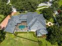 An aerial view showcasing the home's tile roof and screened-in pool area at 9907 Beaufort Ct, Windermere, FL 34786