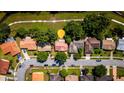 An aerial view showcases the home's location in a neighborhood with tree-lined streets and convenient access to a park at 10423 Manassas Cir, Orlando, FL 32821