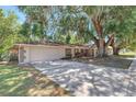 Well-maintained home featuring a spacious driveway and lush, mature landscaping at 107 Larkwood Dr, Sanford, FL 32771