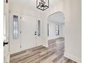 Bright and modern foyer featuring new flooring and fresh paint at 107 Larkwood Dr, Sanford, FL 32771