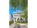 Charming two-story home with black shutters, a landscaped yard, and shade trees at 1117 Damask St, Celebration, FL 34747