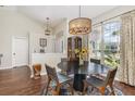 A dining room featuring a modern chandelier, decorative rug, and a large window at 11506 Clair Pl, Clermont, FL 34711
