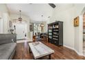 Open-concept home with dark wood flooring, statement shelving, and ample natural light at 11506 Clair Pl, Clermont, FL 34711