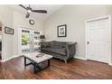 Cozy living room featuring dark wood flooring, neutral paint, and access to the pool area at 11506 Clair Pl, Clermont, FL 34711