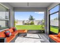 Screened-in patio with modern outdoor furniture and view of the backyard at 1210 Pando Loop, Orlando, FL 32824