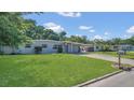 Charming single-story home featuring a lush green lawn and inviting curb appeal at 132 W Lauren Ct, Casselberry, FL 32730