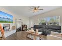 Cozy living room featuring sleek floors, a leather sofa, and ample natural light at 132 W Lauren Ct, Casselberry, FL 32730