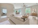 Bright, open living room with modern furnishings, ceiling fan, and natural light showcasing the spacious layout at 13245 Shore Dr, Winter Garden, FL 34787