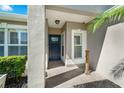 Covered front porch with decorative columns, tile flooring and a blue front door at 145 Circle Hill Rd, Sanford, FL 32773