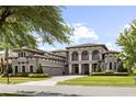 Charming two-story home with arched entryways, mature landscaping, and a three-car garage at 14700 Avenue Of The Rushes, Winter Garden, FL 34787