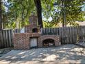 Outdoor brick kitchen with pizza oven and cooking space, ideal for entertaining and grilling at 148 Oak View Cir, Lake Mary, FL 32746