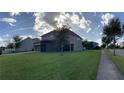 Spacious backyard with a well-maintained lawn and a screened patio, perfect for outdoor relaxation and entertainment at 14841 Porter Rd, Winter Garden, FL 34787