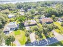 Aerial view showcasing a home surrounded by lush greenery, neighboring properties, and a nearby body of water at 1617 Hontoon Rd, Deland, FL 32720