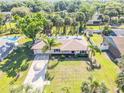 Aerial view of a well-maintained single-story home with mature trees, a pool, and a long driveway at 1617 Hontoon Rd, Deland, FL 32720