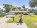 Charming single-story home with a well-maintained lawn, mature trees, and a concrete driveway at 1617 Hontoon Rd, Deland, FL 32720