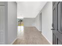Bright, open-concept living room showcasing tile floors, neutral walls, and sliding glass doors to the backyard at 2308 Glenbrook Chase Blvd, Lakeland, FL 33811