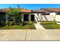 Inviting single-story home with well-manicured front yard and walkway to front door at 2348 Sun Valley Cir, Winter Park, FL 32792