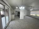 Open-concept living area with sliding glass doors leading to a screened-in patio at 2435 W Park Dr., Deland, FL 32724