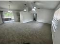 Spacious living room featuring plush carpeting, vaulted ceilings, and ample natural light at 2435 W Park Dr., Deland, FL 32724